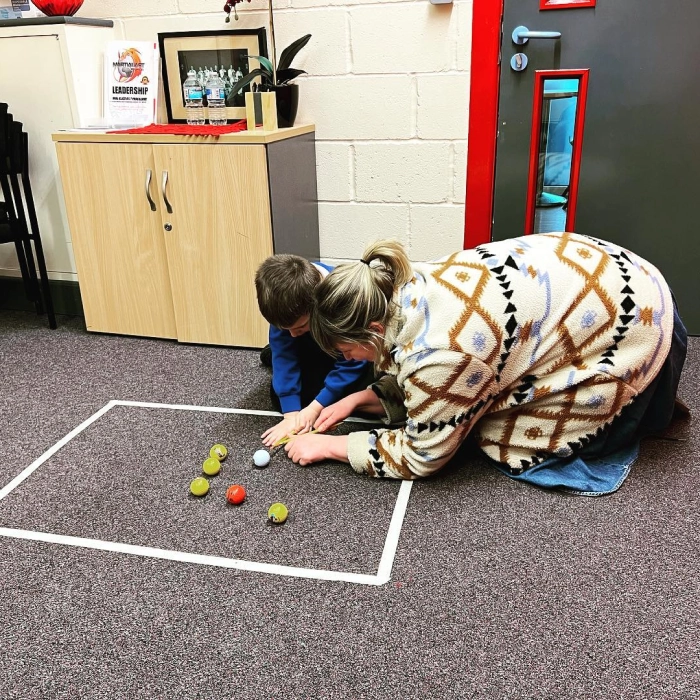 Mother and her child doing fun activity on the floor